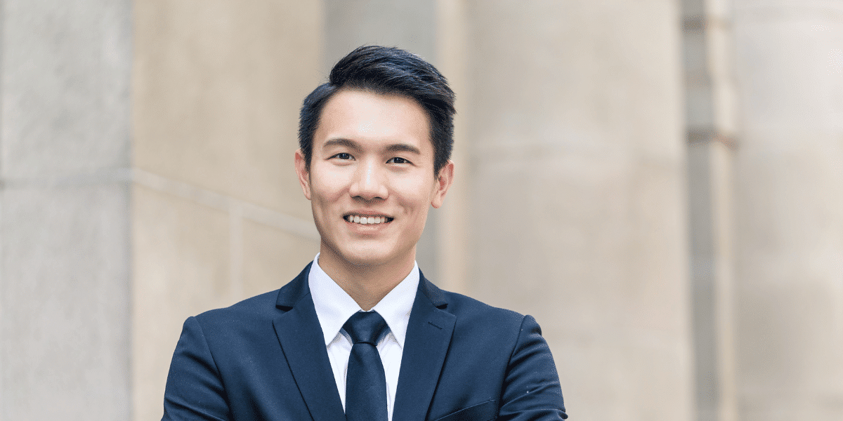Alex, a young professional, smiling confidently in a suit, representing residents of Toronto’s Financial District