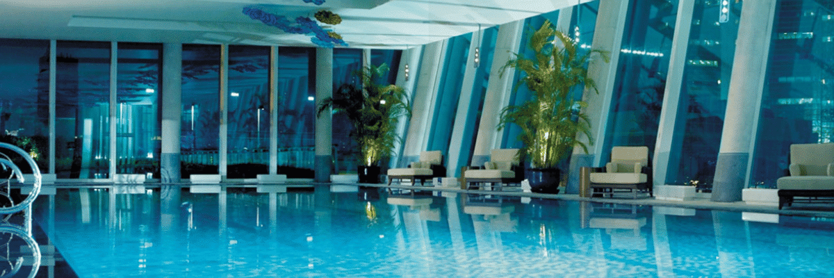 Luxurious indoor pool and lounge area within the Shangri-La Hotel Residences in Toronto, featuring floor-to-ceiling