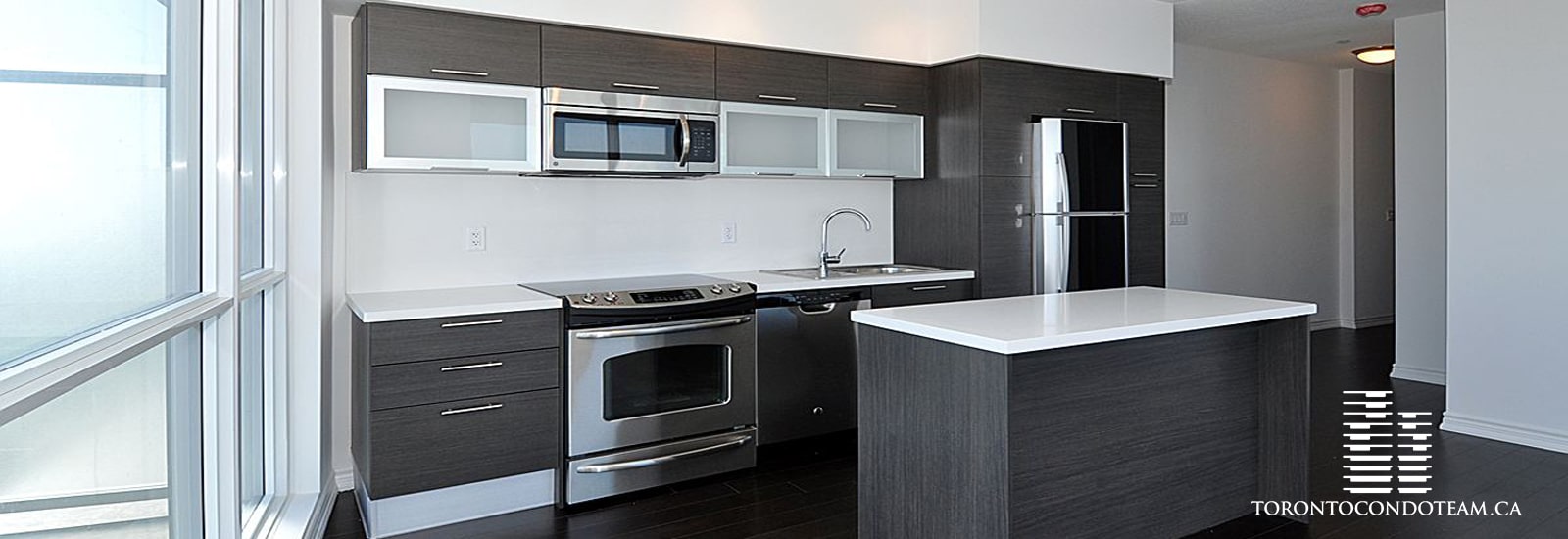 Modern kitchen interior at Aura Condos on Yonge Street in Toronto, showcasing stainless steel appliances