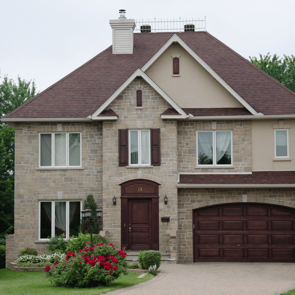 Elegant two-story home with a stone facade and attached garage, representing Toronto real estate options