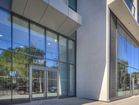 Modern condominium building exterior at 1238 Dundas Street East, a featured listing in Toronto's East