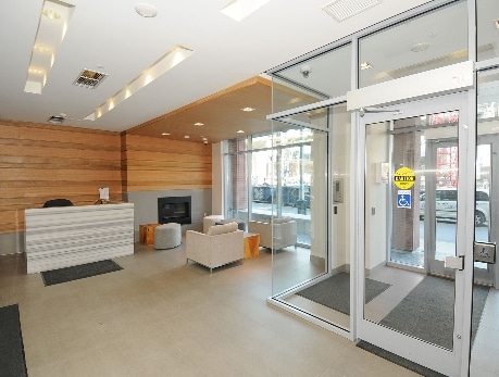 Modern condo lobby entrance at 50 Bruyeres Mews in Fort York, Toronto, showcasing a welcoming