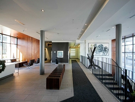 Modern condo lobby interior showcasing a welcoming space with wood accents, seating, and large windows