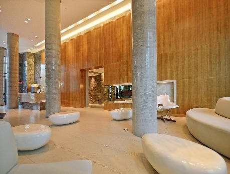 Modern lobby interior of Neptune 1 condo building in Fort York, Toronto, showcasing elegant wood