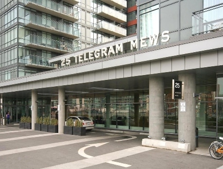 Exterior view of the 25 Telegram Mews condo building in Toronto's CityPlace, showcasing its entrance