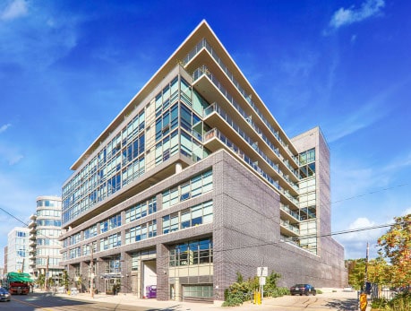Modern condo building at 319 Carlaw Avenue in Toronto’s vibrant East End, showcasing desirable East