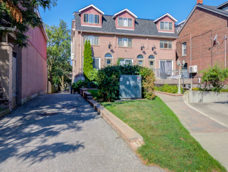 Exterior view of 32 Curzon Street townhomes in Toronto's East End, showcasing brick facades