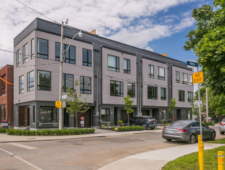 Modern townhomes at Leslieville Four, a condo development in Toronto’s East End, featuring gray facades