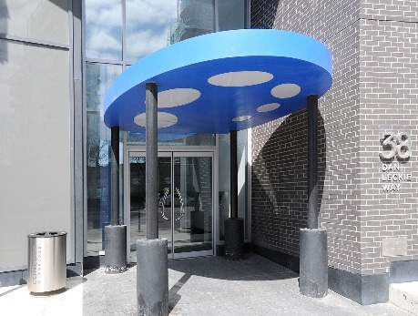 Modern condo building entrance at 38 Dan Leckie Way in Toronto’s CityPlace, showcasing unique blue