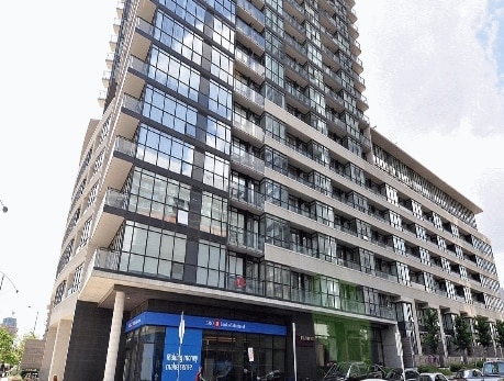 Modern condominium building in Toronto’s CityPlace neighborhood, featuring glass balconies and a ground-level entrance, highlighting