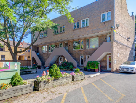 Exterior view of a brick townhouse building at 83 Pape Avenue in Toronto’s East End